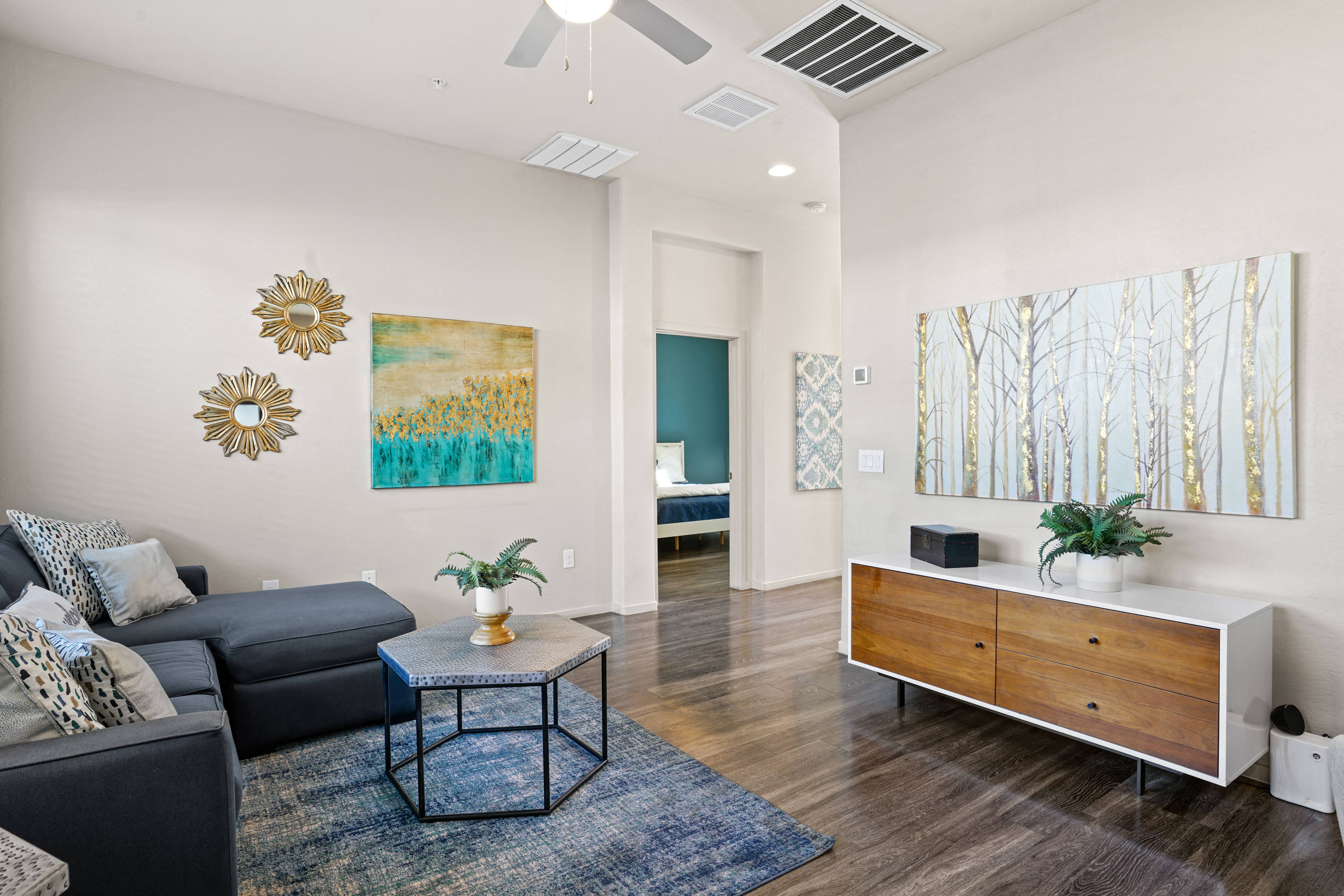 a living room with a couch and a coffee table at Olive Queen Creek Apartments, Queen Creek